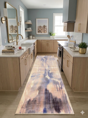 2.8' x 8' runner beige & blue abstract watercolor modern area rug placed in a modern kitchen with light cabinetry and brass accents.