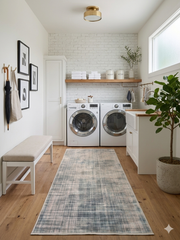 2.8' x 8' runner ivory & blue distressed linear modern area rug placed in a clean laundry room with white cabinetry and modern appliances.