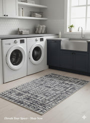 2' x 3' Blue-Gray Ivory Modern Distressed Grid Area Rug placed in a bright laundry room setting.