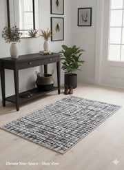 2' x 3' Blue-Gray Ivory Modern Distressed Grid Area Rug placed in a modern entryway with light wood floors.