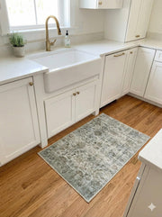 2' x 3' Blue-Gray Light Sage Green Distressed Runner Area Rug placed in a bright kitchen walkway.
