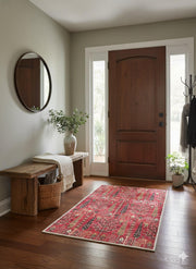 2' x 3' Deep Red Blush Pink Vintage Tribal Area Rug placed in a cozy entryway with dark wood floors