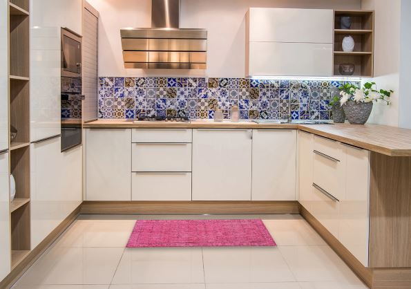 2' x 3' Neon Hot Pink Traditional Persian Runner Rug styled in a modern kitchen, adding a vibrant pop of color against neutral cabinetry and tile flooring.