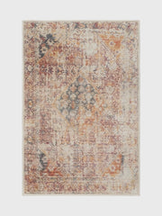 6' x 9' Rectangular Rust Pink Southwestern Tribal Geometric Area Rug featured in a living room with a sofa, coffee table, and brick fireplace backdrop.