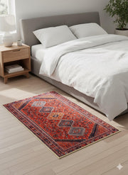 2' x 3' Red Blue Multi Color Geometric Medallion Accent Rug placed in a cozy bedroom setting.