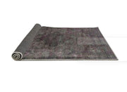 2' x 5' Runner Charcoal Gray & Dusty Purple Modern Oriental Area Rug displayed partially rolled to show the backing.