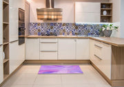 2' x 5' Runner Purple Violet Abstract Area Rug placed in front of kitchen cabinets in a modern kitchen setting.