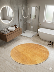 3' Round Yellow Gold Solid Minimalist Modern Area Rug styled in a contemporary bathroom with freestanding tub and glass shower.
