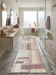 3' x 8' Runner Blush Pink Abstract Geometric Modern Washable Area Rug placed in a spa-inspired bathroom with marble floors, a freestanding tub, and soft pink accents.