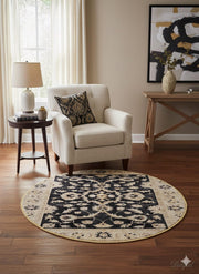 4' round black and ivory floral medallion rug placed beside an accent chair and side table in a cozy living room corner.