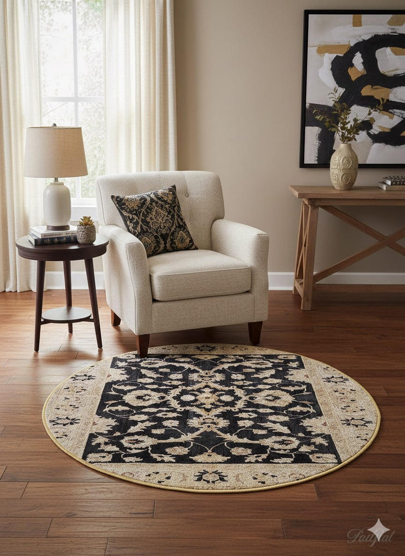 4' round black and ivory floral medallion rug placed beside an accent chair and side table in a cozy living room corner.