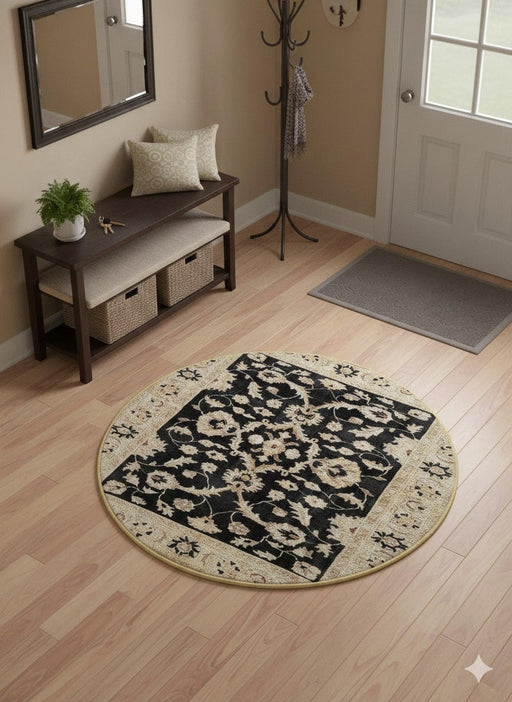4' round ivory, beige, and black floral medallion traditional area rug styled in a welcoming entryway with a wooden bench, wall mirror, and coat rack.
