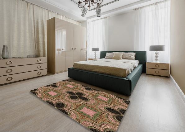 4' x 6' Bronze Brown Pink Patterned Super Soft Cloud Area Rug styled in a modern bedroom setting, highlighting the geometric floral-inspired pattern in bronze brown, pink, and green tones.