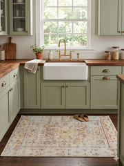 4' x 6' rectangular ivory multicolor distressed floral medallion traditional area rug placed in a cozy kitchen with green cabinetry and a farmhouse sink.