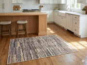 4' x 6' rectangular multi-color & neutral striped modern area rug styled in a contemporary kitchen.