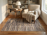 4' x 6' rectangular multi-color & neutral striped modern area rug styled in a cozy reading nook.