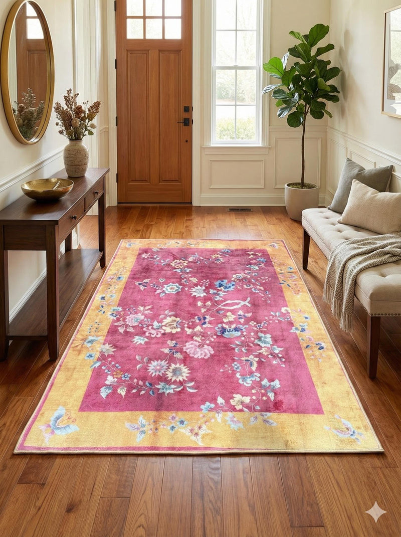 4' x 6' rectangular pink & golden yellow ivory vintage floral traditional area rug placed in a bright entryway beneath a wood console table and round mirror.