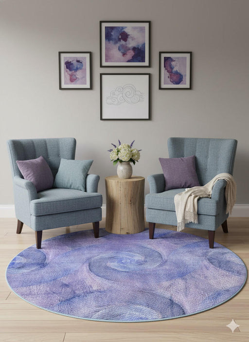 5' Round Lavender Soft Blue Abstract Swirl Area Rug placed in a cozy living room with light wood flooring and natural light streaming through the windows.