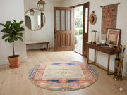 5' Round Peach & Blue Animal Motif Traditional Area Rug styled in an entryway with a console table and wall mirror.