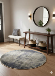5' Round blue & ivory abstract distressed modern area rug placed in a stylish entryway foyer.