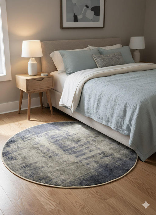 5' Round blue & ivory abstract distressed modern area rug styled in a contemporary bedroom.