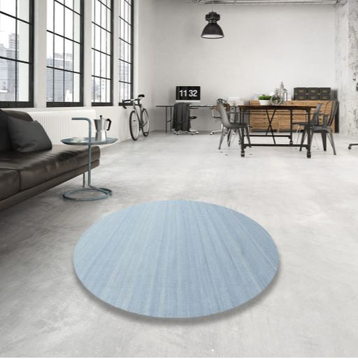 5 ft Round Light Blue & Soft Gray Subtle Striated Contemporary Modern Area Rug styled in a bright industrial living room.