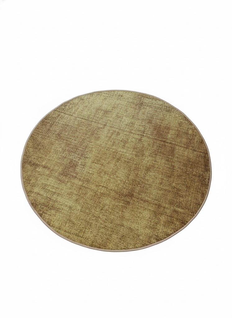 5' round washable area rug featuring a soft golden ochre and warm honey tone with a subtle solid textured finish and minimalist modern design.