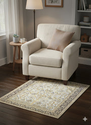5' x 5' square ivory taupe beige floral traditional area rug styled beneath an accent chair in a cozy reading nook with dark wood floors.