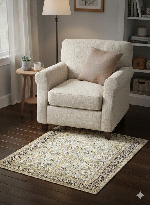 5' x 5' square ivory taupe beige floral traditional area rug styled beneath an accent chair in a cozy reading nook with dark wood floors.