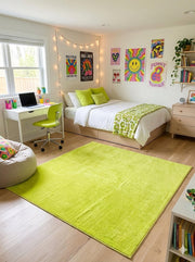 5' x 5' square lime green & solid modern area rug styled in a vibrant bedroom with wood cabinet and work table on the side 