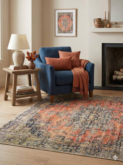 5' x 5' square multi-color & coral blue distressed medallion traditional area rug styled in a cozy living room.