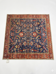 5' x 5' square navy blue & red floral medallion traditional area rug isolated on a white background.