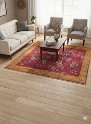 5' x 5' square red and gold floral traditional area rug placed in a bright living room with cream sofa and patterned accent chairs.