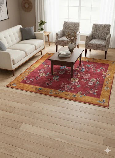 5' x 5' square red and gold floral traditional area rug placed in a bright living room with cream sofa and patterned accent chairs.