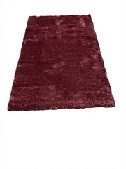 5' x 7.7' deep burgundy wine red undertones solid plush area rug featuring a thick, soft shag texture in a rich solid finish.