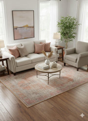 5' x 7' Blush & Beige Ivory Light Taupe Distressed Traditional Area Rug placed in a cozy living room beneath a round coffee table with neutral seating.