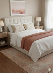 5' x 7' Blush & Beige Ivory Light Taupe Distressed Traditional Area Rug placed in a serene bedroom with neutral bedding, soft natural lighting, and a calm ambiance.