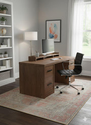 5' x 7' Blush & Beige Ivory Light Taupe Distressed Traditional Area Rug placed under a wooden desk in a stylish home office with ample natural light and elegant bookshelves.