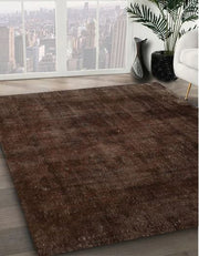5' x 7' Brown Distressed Solid Modern Area Rug displayed in a modern interior showing the distressed finish and simple solid design that adds depth and warmth to the space.