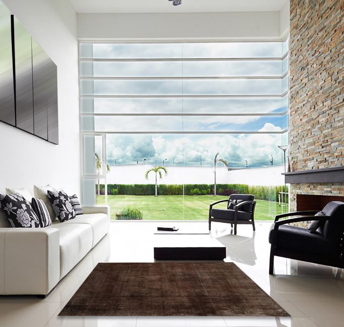 5' x 7' Brown Distressed Solid Modern Area Rug styled in a contemporary living room featuring a rich brown tone with a subtle distressed texture for a modern minimalist look.