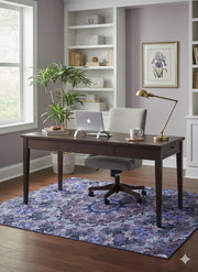 5' x 7' Purple Indigo Blue Floral Medallion Vintage-Style Area Rug displayed in a bright home office with a wooden desk, modern chair, and decorative shelving.