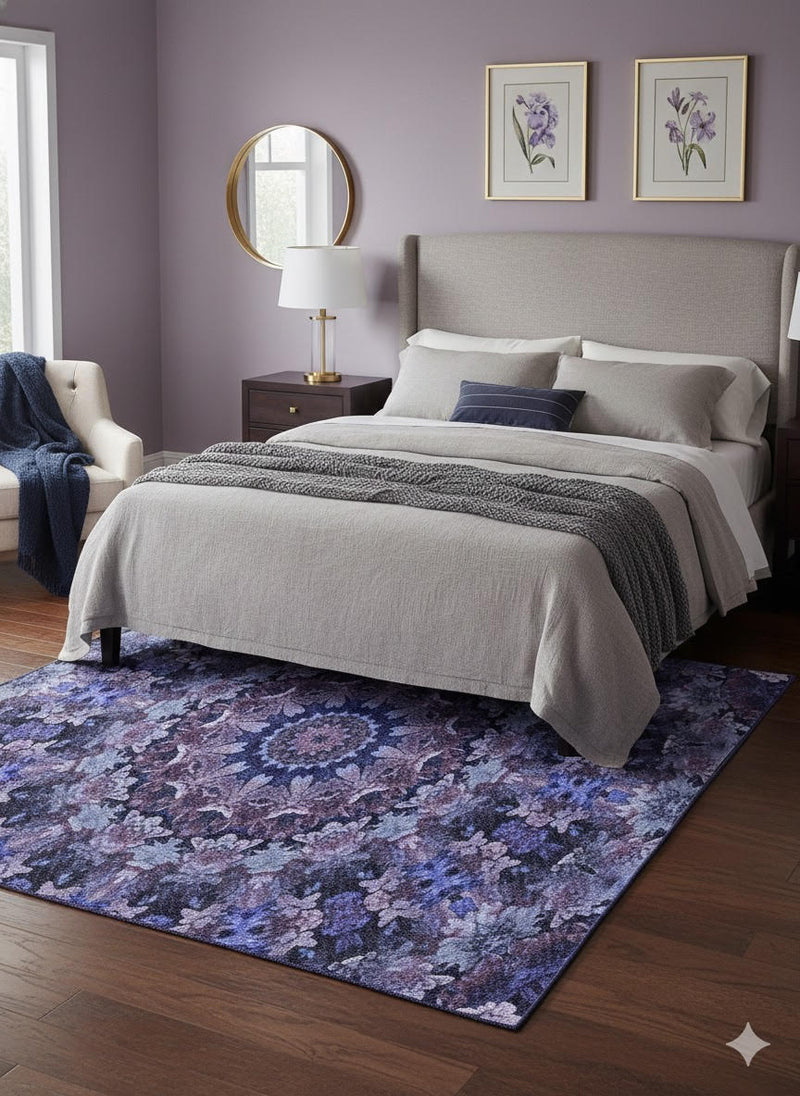 5' x 7' Purple Indigo Blue Floral Medallion Vintage-Style Area Rug placed in a soft lavender-toned bedroom beneath a bed with neutral bedding and warm lighting.