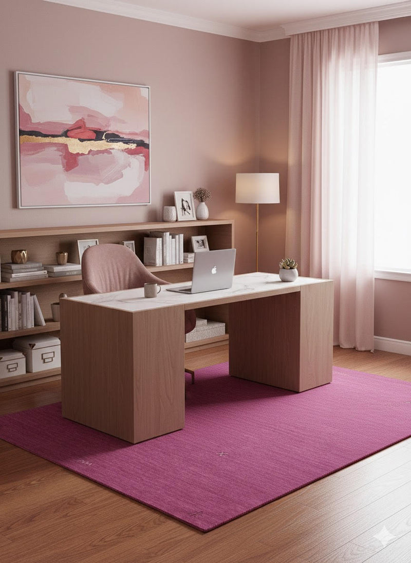 5' x 7' Rectangle Magenta Purple Minimalist Solid Area Rug placed in a contemporary home office with a wooden desk, pink chair, and soft blush décor accents.