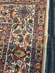 5' x 7' Rectangular Brown & Beige Floral Traditional Washable Area Rug close-up showing detailed floral border and finished edge.