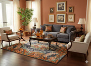 5' x 7' Rectangular Charcoal & Rust Orange Floral Traditional Area Rug styled in a living room with a dark gray sofa and wooden coffee table.