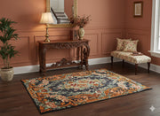 5' x 7' Rectangular Charcoal & Rust Orange Floral Traditional Area Rug styled in an elegant entryway with a carved wooden console table and floral accent chair.