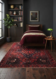 5' x 7' Rectangular Dark Red Black Distressed Geometric Medallion Traditional Area Rug placed in a bedroom with a wooden bed and burgundy bedding.