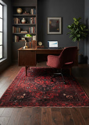 5' x 7' Rectangular Dark Red Black Distressed Geometric Medallion Traditional Area Rug styled in a home office with a wooden desk and burgundy office chair.