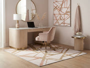 5' x 7' Rectangular Ivory & Gold Blush Geometric Abstract Modern Washable Area Rug styled in a home office with a cream desk and blush velvet chair.