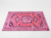 5' x 7' Rectangular Magenta Pink Distressed Tribal Geometric Bohemian Area Rug featuring bold diamond medallions, black tribal motifs, and a decorative pink border.